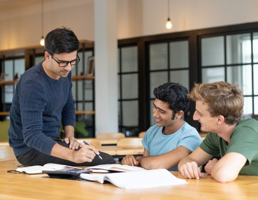 serious-teacher-checking-assignment-two-students_1262-15174